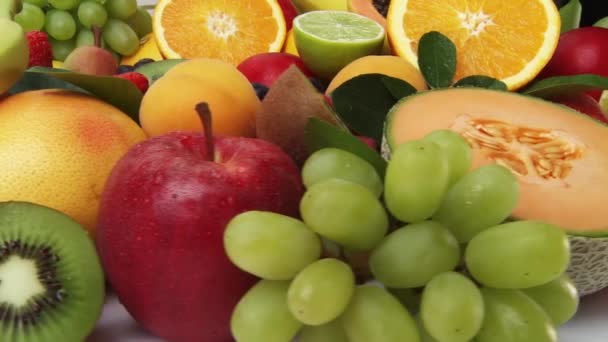 Assorted fruits on white background — Stock Video