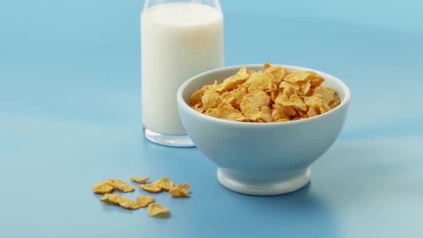 Чаша кукурузных хлопьев и бутылка молока — стоковое видео