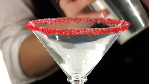 Cosmopolitan being pour into glass — Stock Video