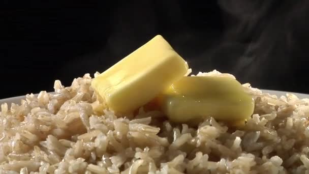 Rice with knobs of butter — Stock Video