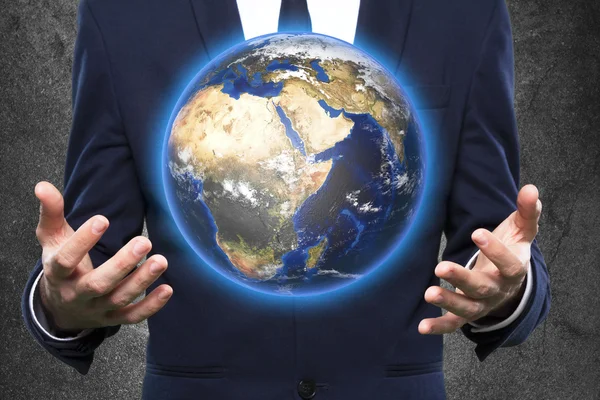 Businessman holds Earth in a hand — Stock Photo, Image