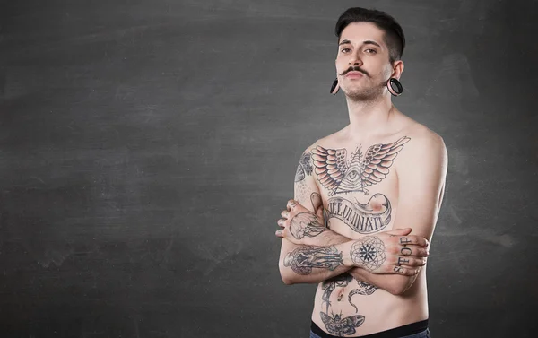 Beautiful tattooed man on wall — Stock Photo, Image