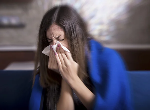 Sick young woman is coughing and blowing. — Stock Photo, Image