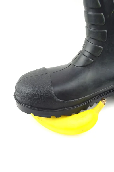 Black rubber boots with banana — Stock Photo, Image
