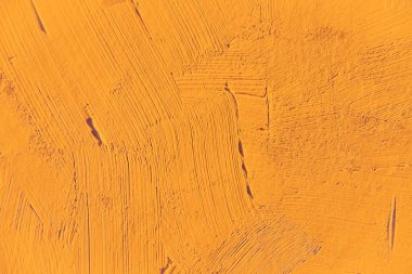 Yakın plan boyama. Açık turuncu renkli arka plan. Canlı, renkli, yaratıcı arkaplanlar için. Tuvaldeki yağ fırça darbelerinin dokusunu etkiler. Web ve tasarım için.