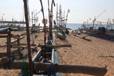  old wooden fishing boats on beach in india  clipart