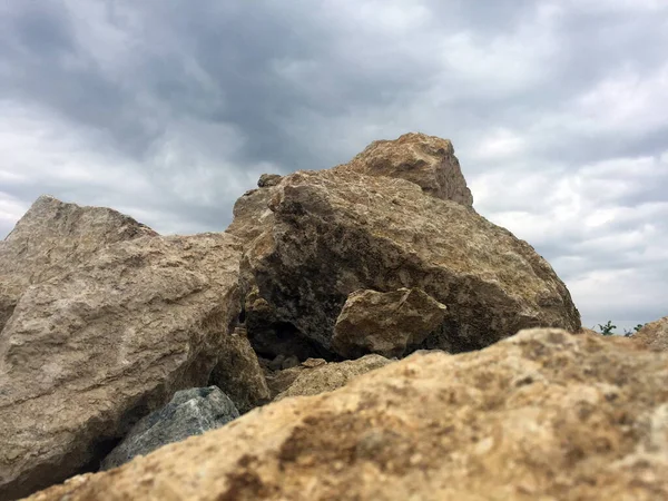 İlginç ve yaratıcı arka planlar için bulutlu gökyüzüne sahip kaya parçaları.