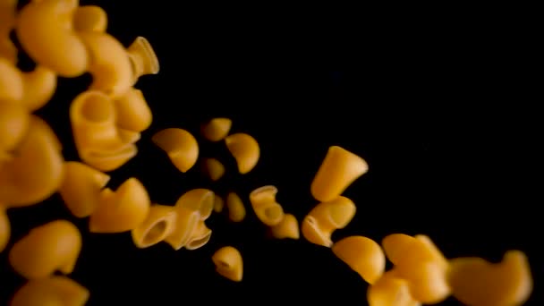 Italian Pasta Pipe Rigate falling into dark background in slow motion — Stock Video