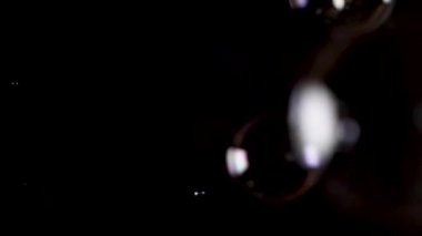 Sabun köpükleri soldan sağa doğru ağır çekimde yüzer..