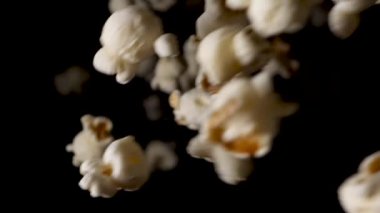 Popcorn empties out in the cinema on the floor, slow motion.