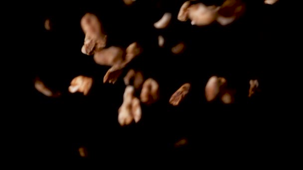 Delicious puffed honey cornflakes falling down on black background — Stockvideo