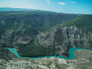 Deapest canyon gorge in the would in Dagestan and green river Sulac on the bottom of mountains under blue sky