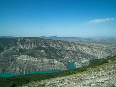 Deapest canyon gorge in the would in Dagestan and green river Sulac on the bottom of mountains under blue sky