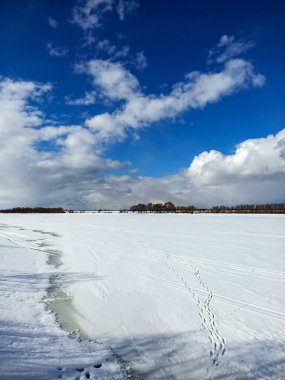 Güneşli mavi gökyüzünün altındaki vadide beyaz kış karı