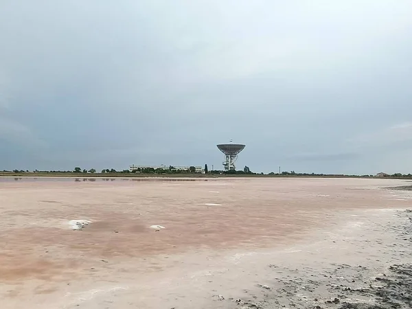 Cosmic radar at the dried pink salt lake in bad weather