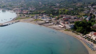 Korfu Yunanistan 'ın Sandy Roda Sahil Kıyısı Hava Aracı Görüntüsü Şemsiye güneşlikleri ve dinlenme tesisi yakınlarındaki Sakin Mavi Deniz Suyu ile