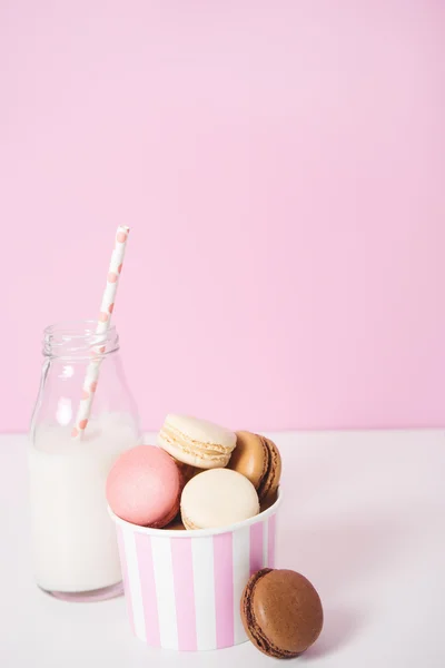 Macaroons diferentes com garrafa de leite — Fotografia de Stock