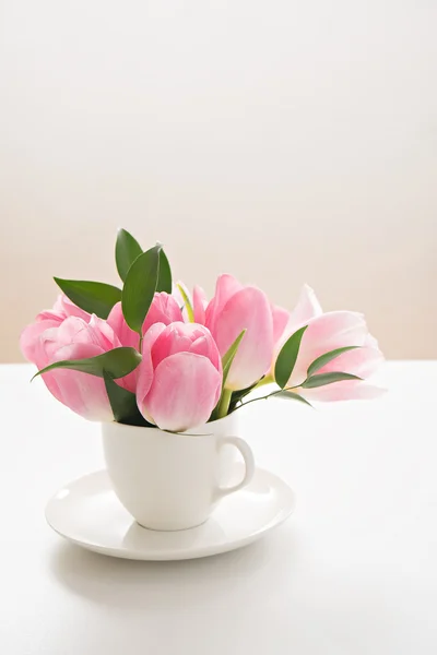 Tulipanes rosados frescos de primavera en taza sobre fondo blanco — Foto de Stock