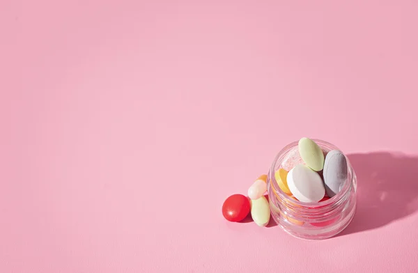 Concept theme.bright pills on pink background — Stock Photo, Image