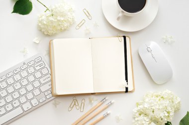 Ofis resepsiyon masası bilgisayar, sarf malzemeleri ve kahve fincanı ile