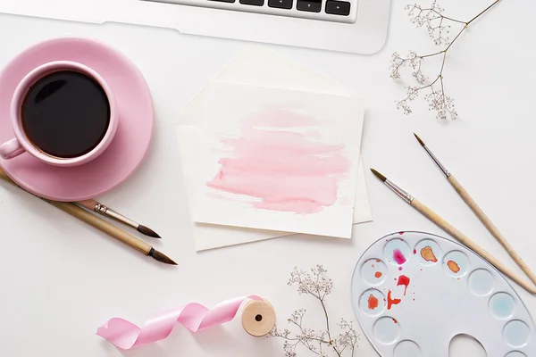 Workspace with watercolor paintings, palette and brush at white — Stock Photo, Image