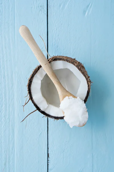 Coconuts with coconut oil on table — Stock Photo, Image