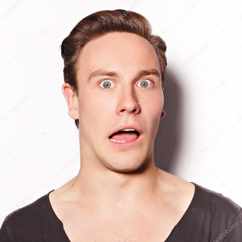Close up of a scared young man on white background