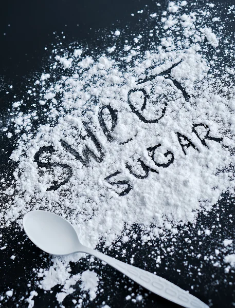 黒いテーブルの上のスプーンで白い砂糖 — ストック写真