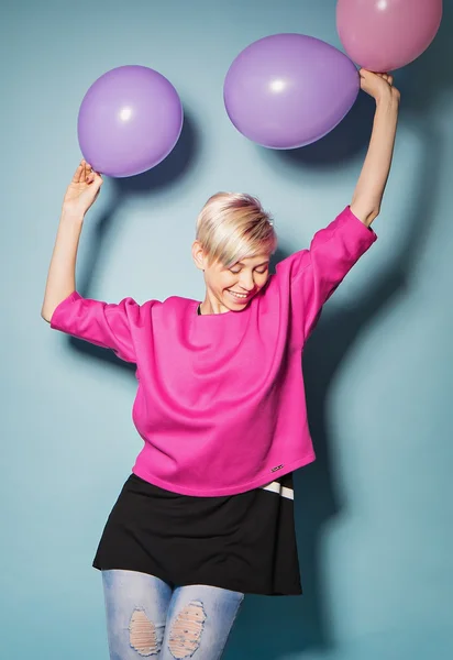 Girl have fun with colored balloons on blue background — Stock Photo, Image