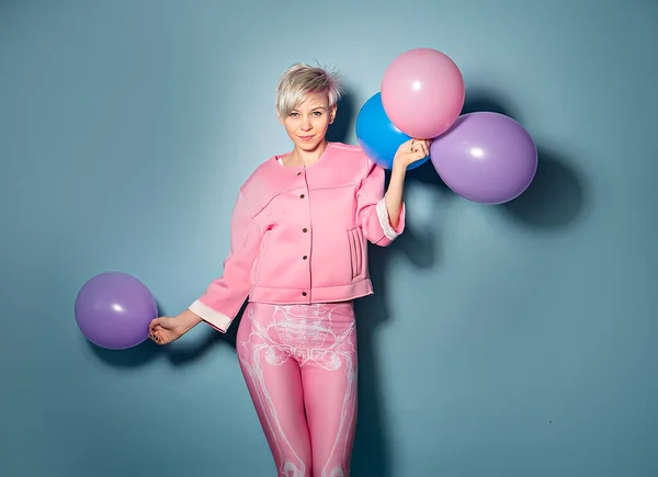 Girl have fun with colored balloons on blue background — Stock Photo, Image