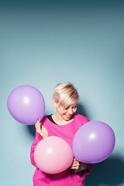 Lány jó szórakozást a színes buborékok a kék háttér — Stock Fotó