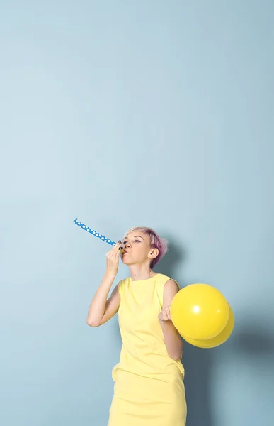 Dziewczyna zabawy z kolorowych balonów na niebieskim tle — Zdjęcie stockowe