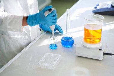 Tıbbi araştırma için laboratuvar hazırlama test örneklerinde çalışan genç bir kadın.