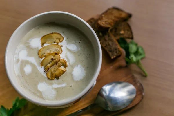 Homemade mushroom soup in a bowl on the wood table — Stock Image Homemade mushroom soup in a bowl on the wood table Royalty Free Stock Photos