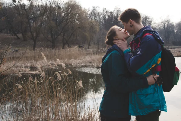 Young beautiful happy hipster couple brunette girl and guy having great fun time while travelling and walking in the woods forest — Stock Photo, Image