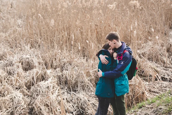 Young beautiful happy hipster couple brunette girl and guy having great fun time while travelling and walking in the woods forest — Stock Photo, Image