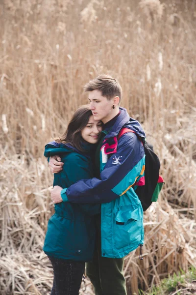 Young beautiful happy hipster couple brunette girl and guy having great fun time while travelling and walking in the woods forest — Stock Photo, Image