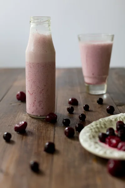 Fresh organic blackberry cherry smoothie made of homemade yogurt and berries from farmers market on dark wood rustic style background soft focus overhead-angle shot — Stock Photo, Image