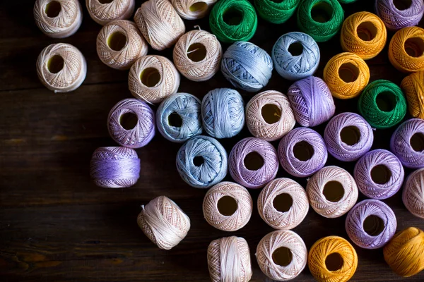 Пряжи нитей для вязания в разных цветах фона темно-деревянный стол деревенский — стоковое фото