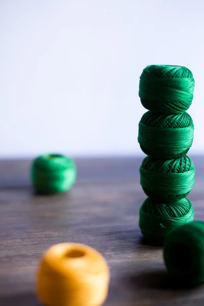 Yarns of threads for knitting on dark wood background rustic — Stock Photo, Image