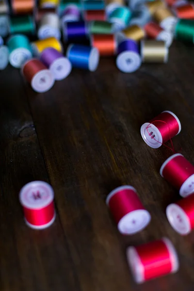 Threads for embroidery and sewing in different colors background soft focus — Stock Photo, Image