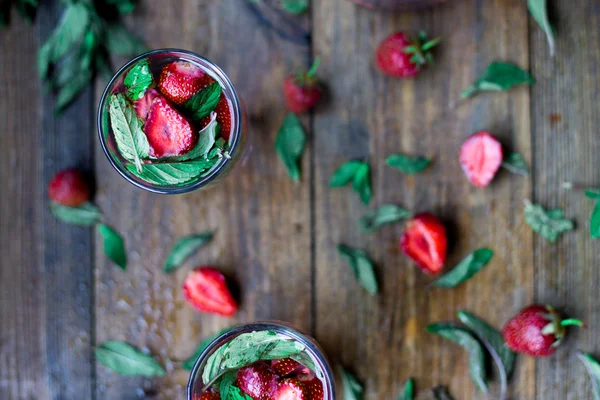 Strawberry mint infused water decorated in rustic style on dark wood table background — Stock Photo, Image