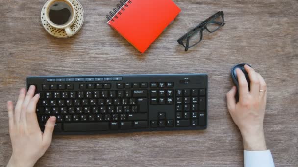 View from above of mans hands typing. — Stock Video