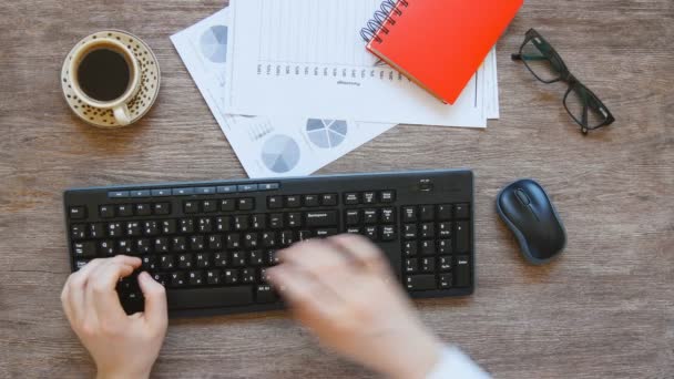 View from above of mans hands typing. — Stock Video