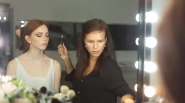 Makyöz makyaj yapıyor