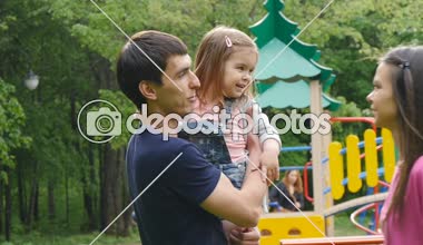 Genç ebeveynler kızlarını öpüyor