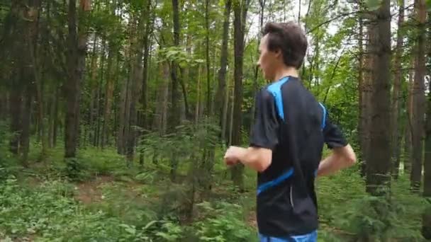 Jogger op een parcours in het woud in slow motion — Stockvideo