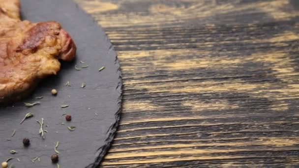 Steak on a wooden table. — Stock Video