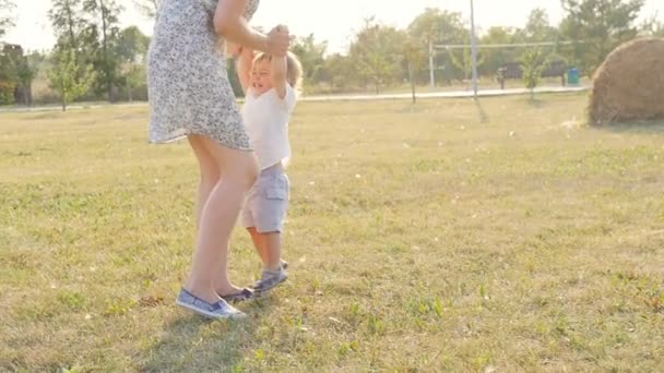 Mor och son spelar i höst park — Stockvideo