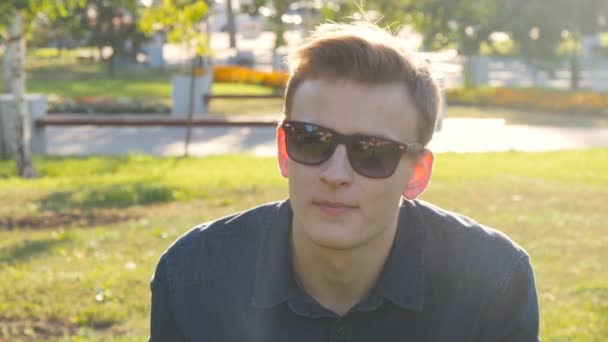 Man with sunglasses relaxing on the grass — Stock Video